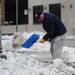 A man shovels heavy melting snow at the corner of W. Huron and N. Ashley streets in downtown Ann Arbor on Wednesday, Feb. 27, 2013.  Melanie Maxwell I AnnArbor.com
